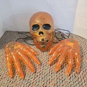 Life size Orange Plastic Skull & Hands Light Up Outdoor Plug In Halloween Decor